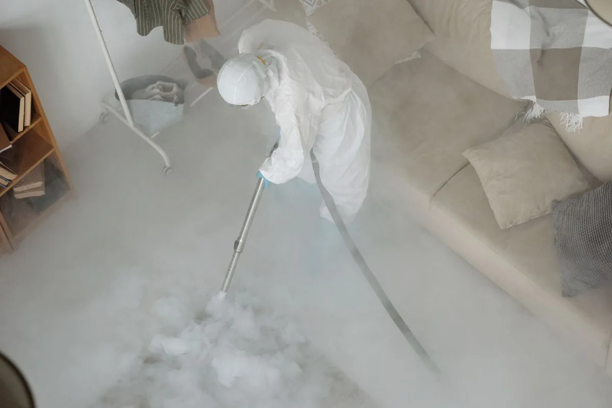 Biohazard cleanup technician in protective equipment, Emerson, NJ